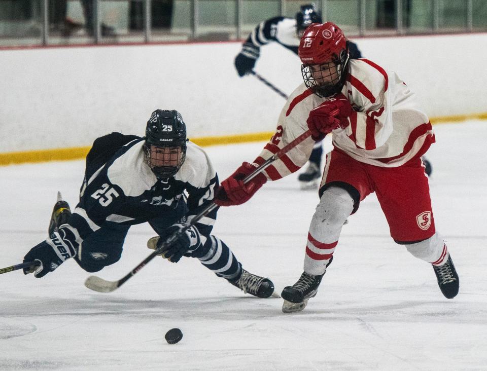 St. John's Prep's J.R. Goldstein goes down trying to catch St. John’s forward Luke Gerardi in the second period.