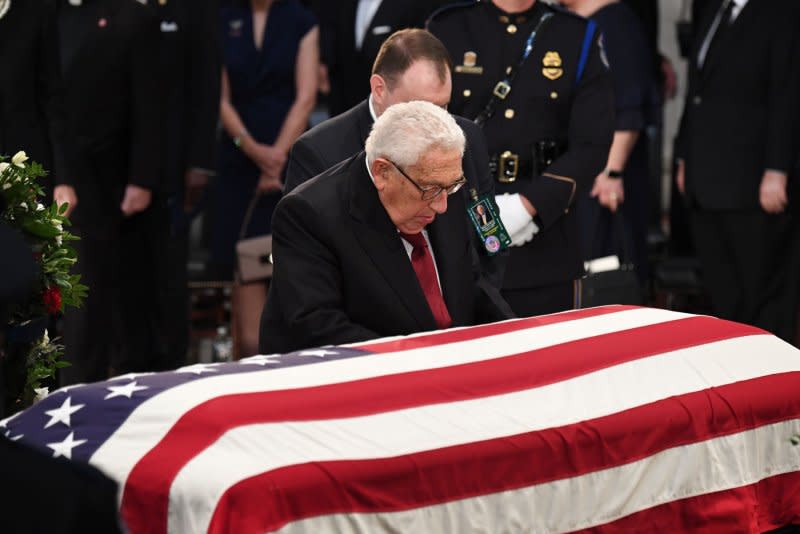 Former Secretary of State Henry Kissinger pays his respects by the casket of Arizona Sen. John McCain as he lies in state at the U.S. Capitol in Washington, D.C., on August 31, 2018. File photo by Pat Benic/UPI