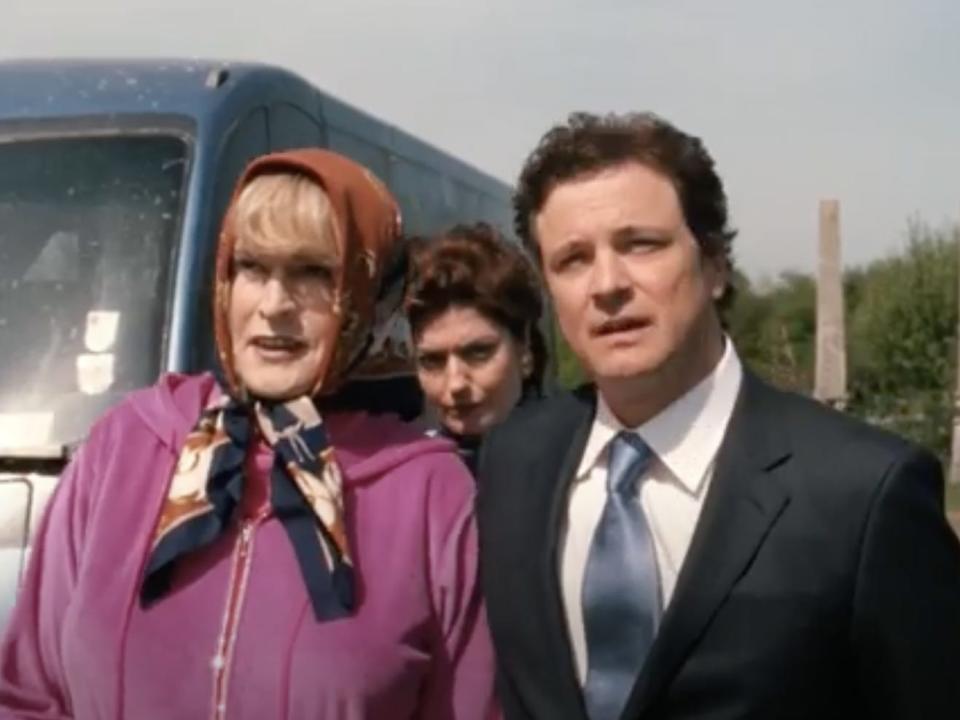 Colin Firth in a suit standing beside Rupert Everett in "St. Trinian's."