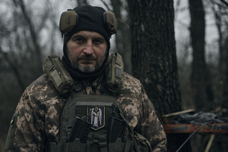 A Ukrainian soldier looks on as he fires an artillery at Russian positions near Bakhmut, Donetsk region, Ukraine, Sunday, Nov. 20, 2022. (AP Photo/LIBKOS)