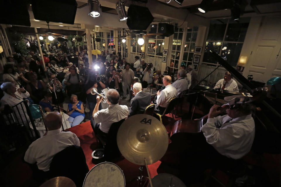 Venerable Dixieland jazz musician Lionel Ferbos performs at his 102nd birthday party at the Palm Court Jazz Cafe in New Orleans, Wednesday, July 17, 2013. Ferbos, who bought his first cornet at a Rampart Street pawn shop when he was 15, is believed to be the oldest actively working musician in the city. His body isn’t without signs of age. He’s been in and out of the hospital in recent years and had a pacemaker implanted last year. He sometimes uses a wheelchair to get around, but he remains determined to sing and blow. (AP Photo/Gerald Herbert)