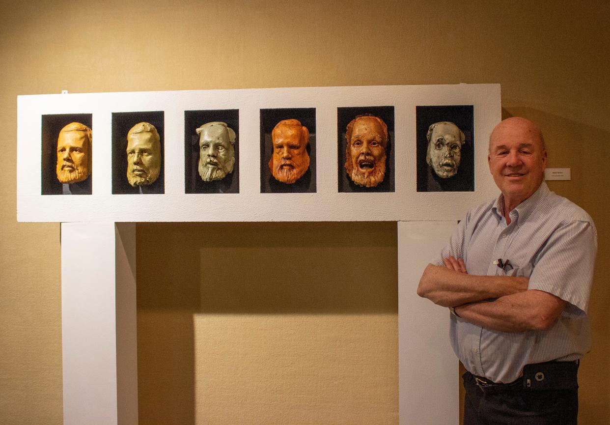 Tuck Langland poses June 11, 2019, with some of his works during an exhibition at the Midwest Museum of American Art in Elkhart. He will address The Art League March 21 at Beiger Mansion in Mishawaka.