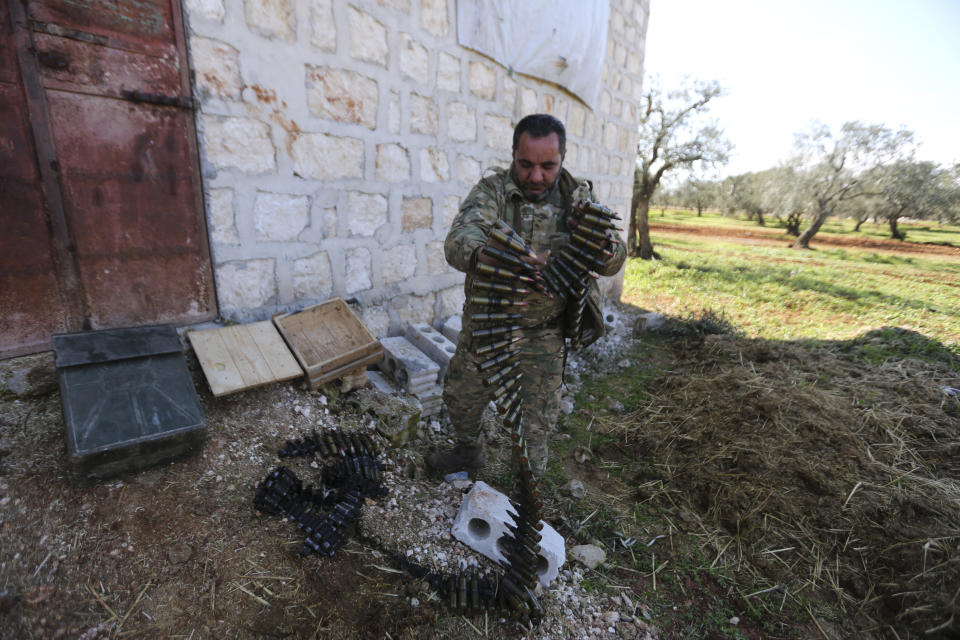 Turkish backed rebel fighters prepare for an attack near the village of Neirab in Idlib province, Syria, Thursday, Feb. 20, 2020. Two Turkish soldiers were killed Thursday by an airstrike in northwestern Syria, according to Turkey's Defense Ministry, following a large-scale attack by Ankara-backed opposition forces that targeted Syrian government troops. (AP Photo/Ghaith Alsayed)