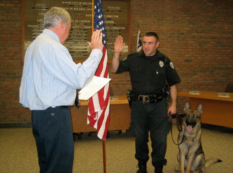 Mayor Dan Ross conducts the swearing-in ceremony of K-9 officer Amigo to the Bucyrus Police Department in May 2008. Amigo was with his handler, Bucyrus police Lt. Neil Assenheimer. Assenheimer is now the city's police chief.