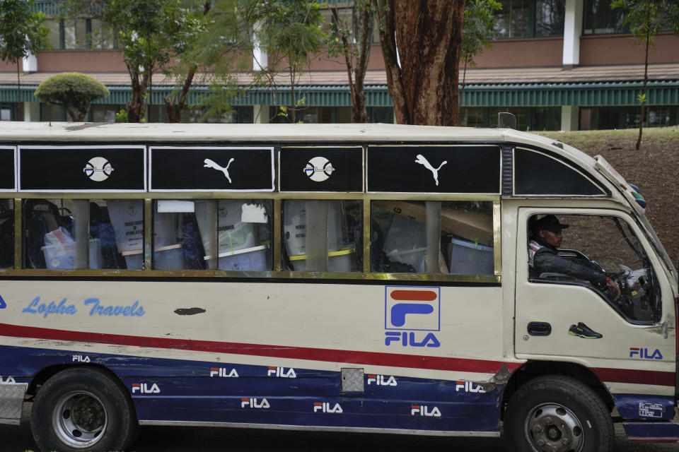 A worker drives in a minibus transporting ballot boxes to a collection and tallying center in Nairobi, Kenya Wednesday, Aug. 10, 2022. Kenyans are waiting for the results of a close but calm presidential election in which the turnout was lower than usual. (AP Photo/Mosa'ab Elshamy)