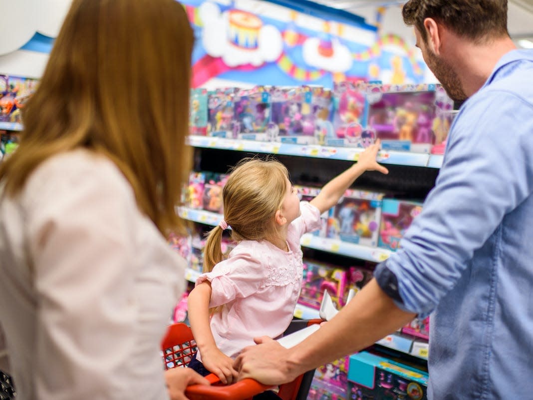 A family shops for toys in a department store.