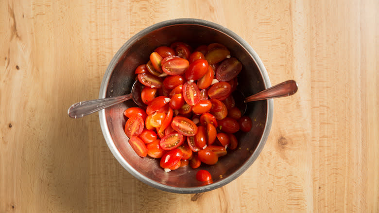 halved grape tomatoes in bowl 