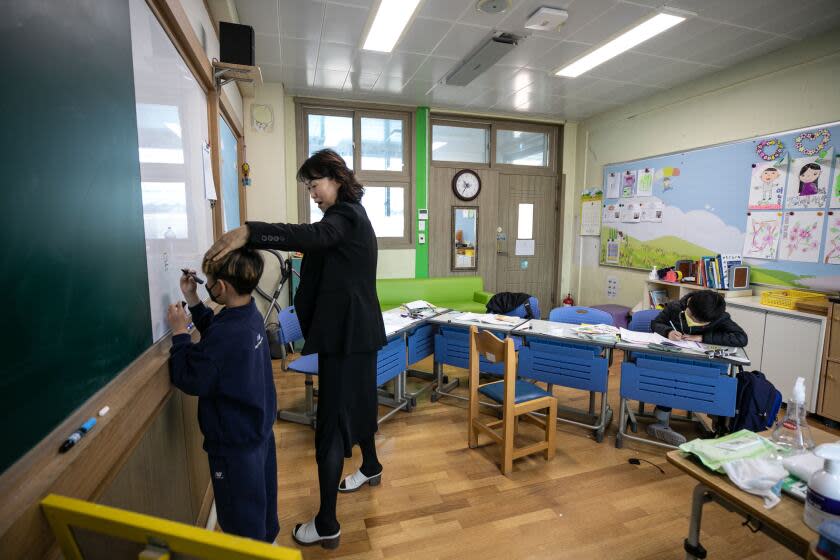 Lee Eun-sook, center, the principal at Dochang Elementary, teaches the Chinese characters to the second graders. The decline of South Korea' rural towns and their schools began with the country's rapid industrialization in the 1960s and 1970s, when farming and fishing villages saw a mass exodus of its young workforces to cities like Seoul. From 1982, education authorities responded to the fall in rural populations by shutting down around 5,000 elementary schools, which had become too small and too costly to maintain.