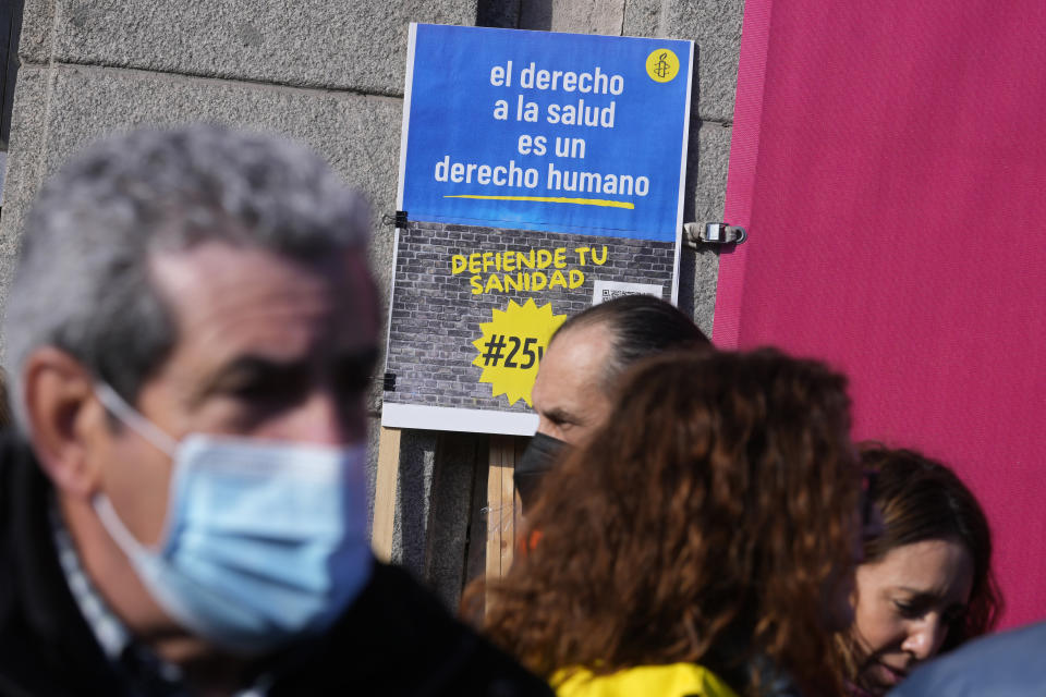 Protesters gather to march to support the public heath service in one of four columns which will meet in the centre of Madrid, Spain, Sunday, Feb. 12, 2023. Several thousand health workers returned to the streets of Spain's capital Sunday to protest what they claim is the dismantling of Madrid's public health care system by its conservative regional government. Placard reads ' The right to health is a human right. Defend the health service'. (AP Photo/Paul White)
