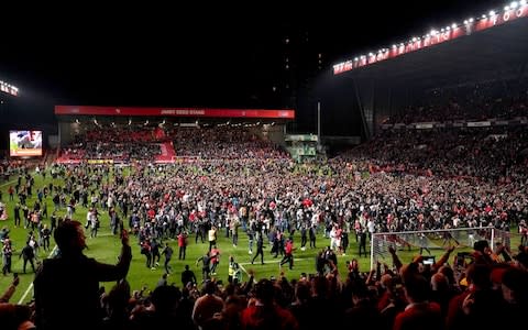 Fans ran onto the pitch at the Valley after Charlton's dramatic penalty shootout victory over Doncaster in the play-offs - Credit: PA