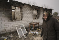 A woman walks by a house destroyed while her village was occupied by Russian troops in Andriivka, Ukraine, Tuesday, April 5, 2022. Ukrainian President Volodymyr Zelenskyy accused Russian troops of gruesome atrocities in Ukraine and told the U.N. Security Council on Tuesday that those responsible should immediately be brought up on war crimes charges in front of a tribunal like the one set up at Nuremberg after World War II.(AP Photo/Vadim Ghirda)