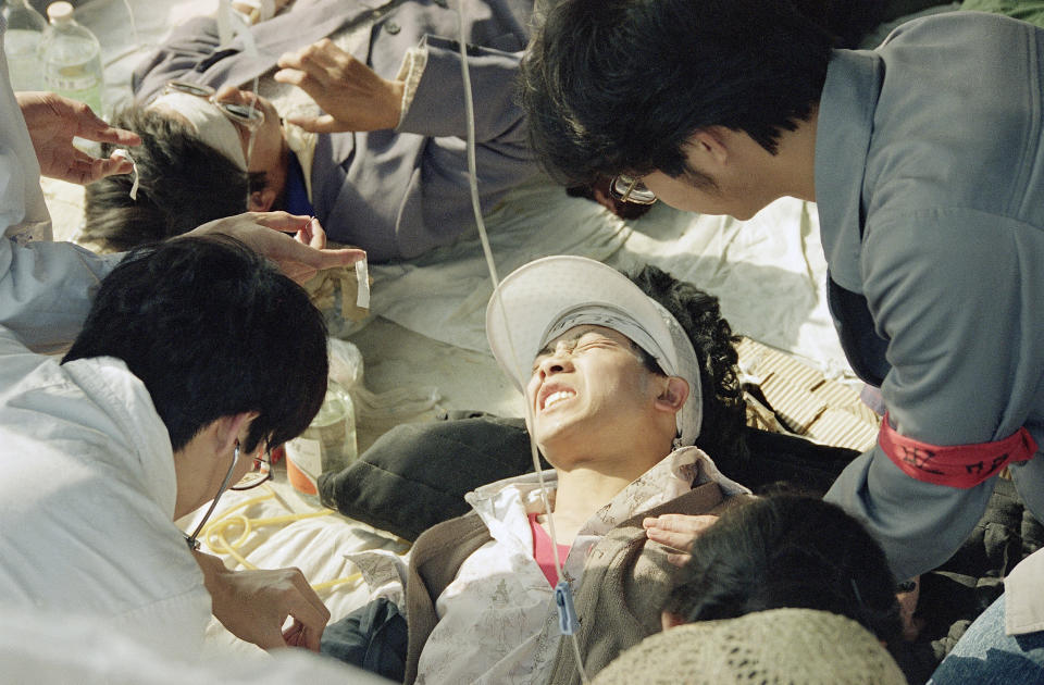 FILE - In this May 17, 1989 file photo, a striking Beijing University student is given first aid by medics at a field hospital in Tiananmen Square at Beijing, the fourth day of their hunger strike for democracy. Over seven weeks in 1989, the student-led pro-democracy protests centered on Beijing’s Tiananmen Square became China’s greatest political upheaval since the end of the decade-long Cultural Revolution more than a decade earlier.(AP Photo/Sadayuki Mikami, File)