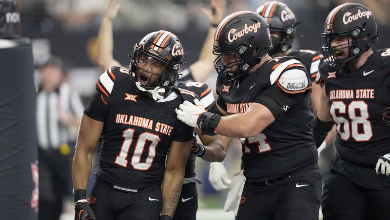 Oklahoma State wide receiver Rashod Owens (10) celebrates after catching a pass for a touchdown with Preston Wilson (74) and Taylor Miterko (68) in the first half of the Big 12 Conference championship NCAA college football game against Texas in Arlington, Texas, Saturday, Dec. 2, 2023. Now former OSU defensive lineman Ricky Lolohea announced Thursday that he is transferring to Utah State.