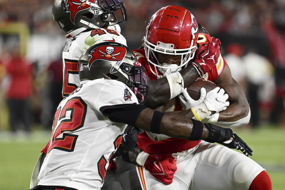 Kansas City Chiefs running back Isiah Pacheco (10) is stopped by Tampa Bay Buccaneers linebacker Devin White (45) and safety Mike Edwards (32) during the first half of an NFL football game Sunday, Oct. 2, 2022, in Tampa, Fla. (AP Photo/Jason Behnken)