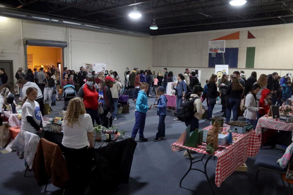 Customers browse the various vendor booths at thef air.