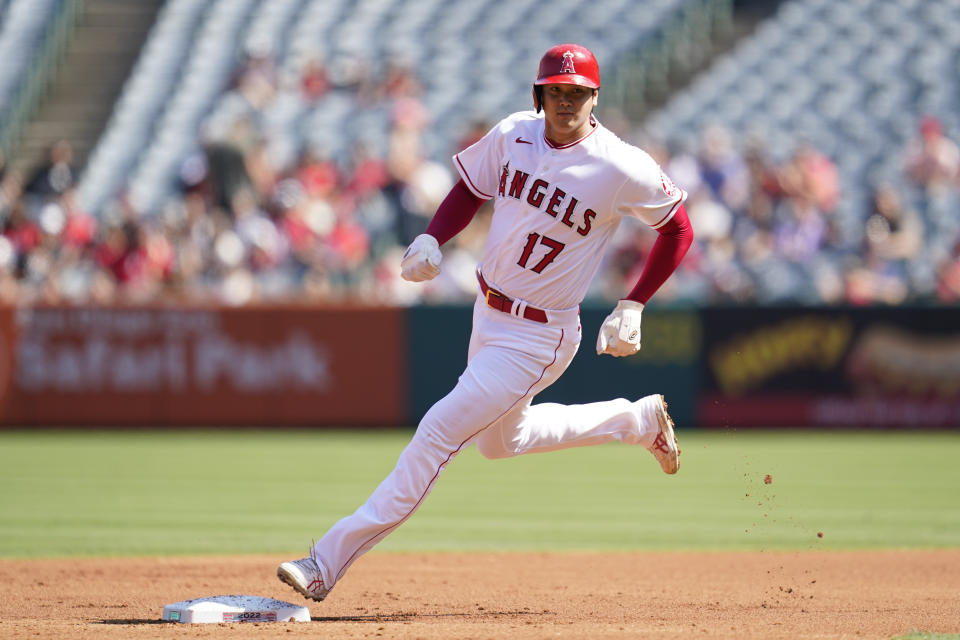 Los Angeles Angels designated hitter Shohei Ohtani (17) rounds second on a single hit by Taylor Ward during the first inning of a baseball game against the Texas Rangers in Anaheim, Calif., Sunday, Oct. 2, 2022. Mike trout scored. (AP Photo/Ashley Landis)