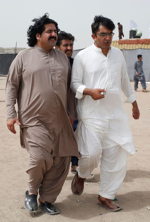Ali Wazir (L) and Mohsin Dawar, leaders of the Pashtun Tahaffuz Movement (PTM) walks at the venue of a rally against, what they say, are human rights violations by security forces, in Karachi, Pakistan May 13, 2018. Picture taken May 13, 2018. REUTERS/Akhtar Soomro
