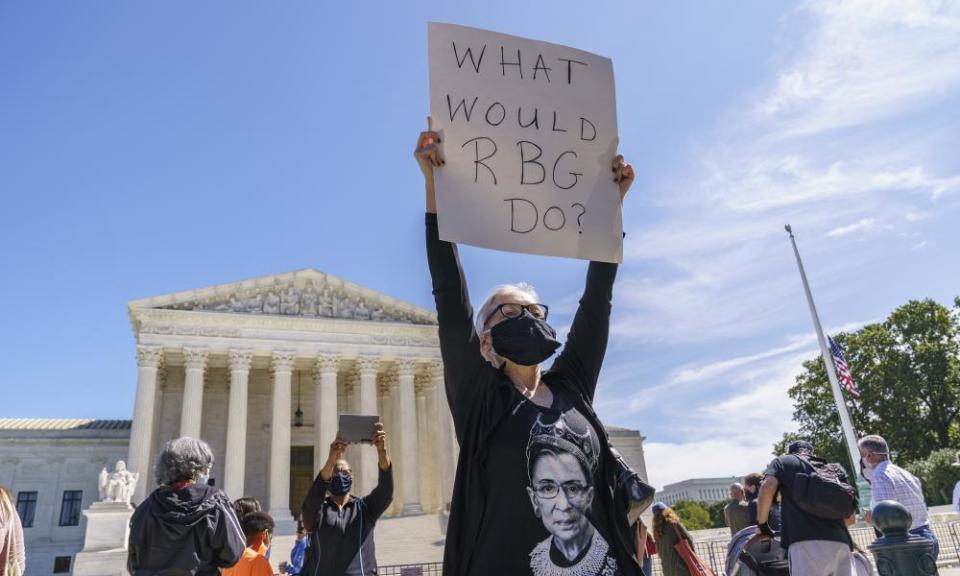 Kelli Midgley, center, an English teacher from Baltimore, joins people gathered at the supreme court to honor Ruth Bader Ginsburg.