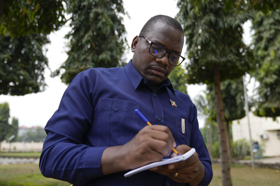 Onesime Niyukuri take notes during an interview with the Associated Press in Bujumbura, Burundi, Sept. 18, 2024. (AP Photo/Brian Inganga)