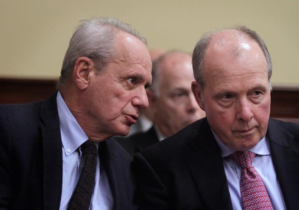 Pawtucket Red Sox co-owner and Chairman Larry Lucchino, left, and PawSox Vice Chairman Mike Tamburro confer during a Senate Finance Committee hearing at the State House in October 2017.