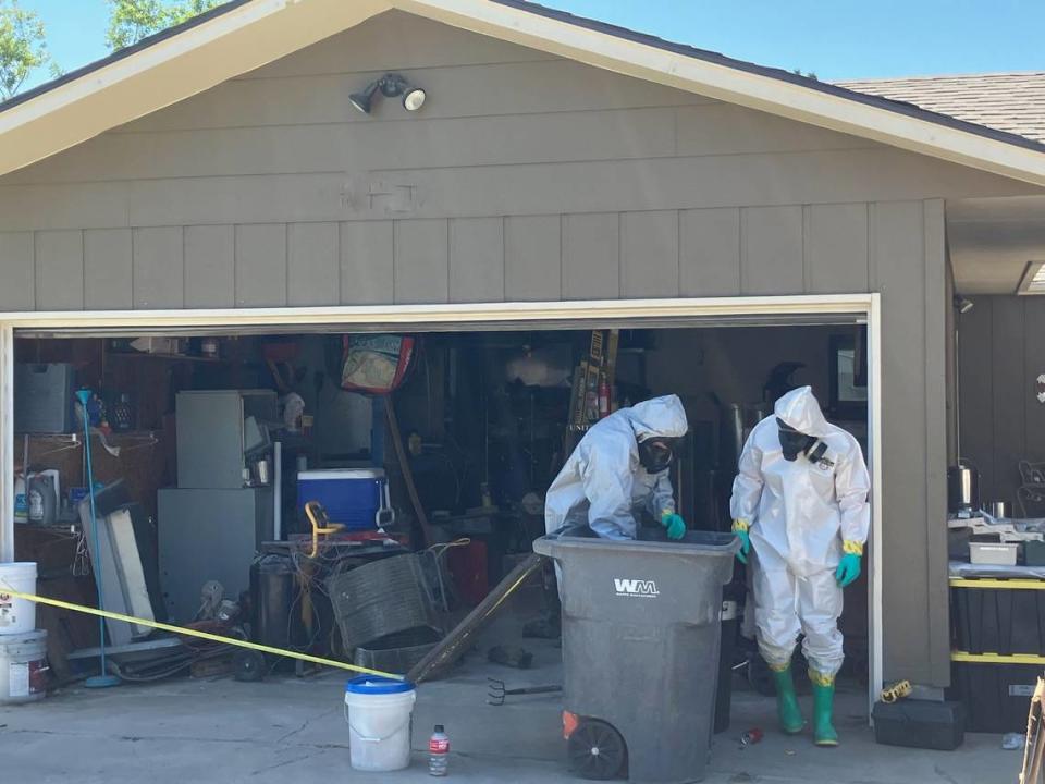 Investigators search through a reported meth lab set up in the garage of a North Quillan Street home in Kennewick. Kennewick Police Department