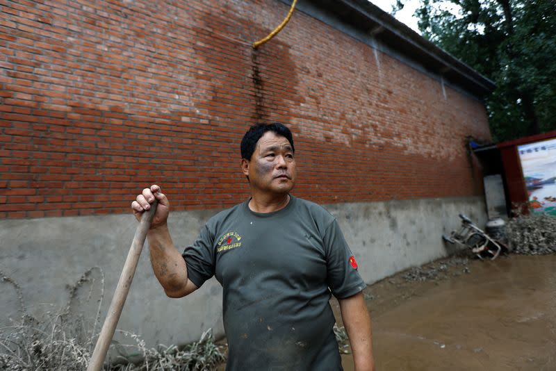 Wang Hui at his damaged home after rain and floods in Zhuozhou