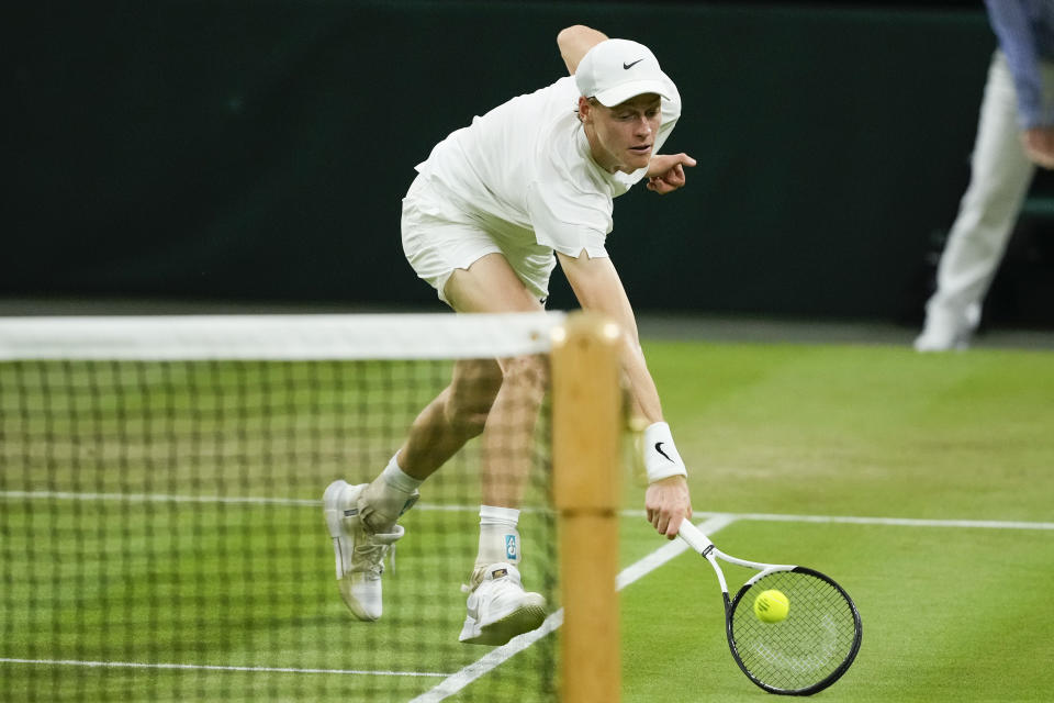 Jannik Sinner of Italy plays a backhand return to Miomir Kecmanovic of Serbia during their third round match at the Wimbledon tennis championships in London, Friday, July 5, 2024. (AP Photo/Mosa'ab Elshamy)