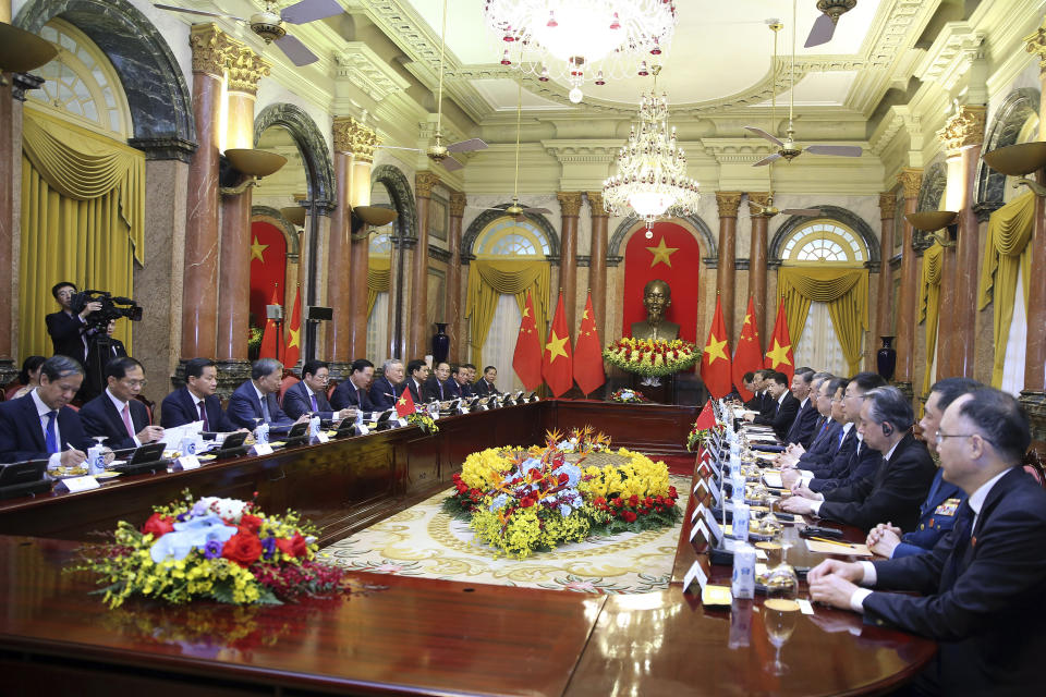 Vietnamese President Vo Van Thuong, sixth left, and Chinese President Xi Jinping, eighth right, meet at the Presidential Palace in Hanoi, Vietnam, Wednesday, Dec. 13, 2023. (Luong Thai Linh/Pool Photo via AP)