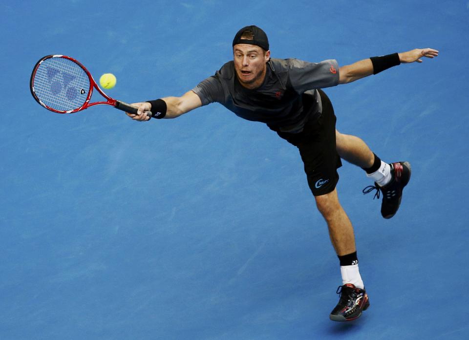 Lleyton Hewitt of Australia reaches for a shot during his men's singles first round match against Zhang Ze of China at the Australian Open 2015 tennis tournament in Melbourne January 20, 2015. REUTERS/Thomas Peter (AUSTRALIA - Tags: SPORT TENNIS)