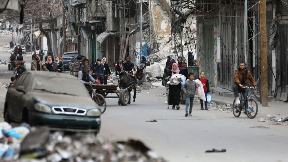 Palestinian residents leave the area with a few items after Israeli forces besiege the Al-Shifa hospital with tanks and heavy gunfire in Gaza City, Gaza on March 18, 2024. - Dawoud Abo Alkas/Anadolu/Getty Images