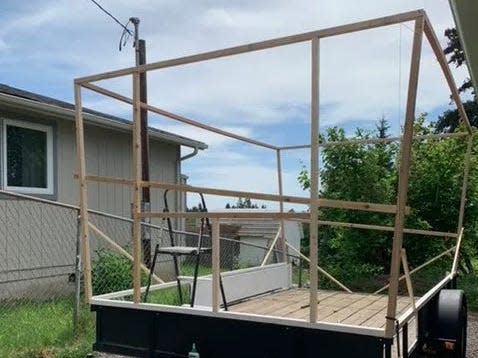 The wall frames being set up on the flatbed trailer.