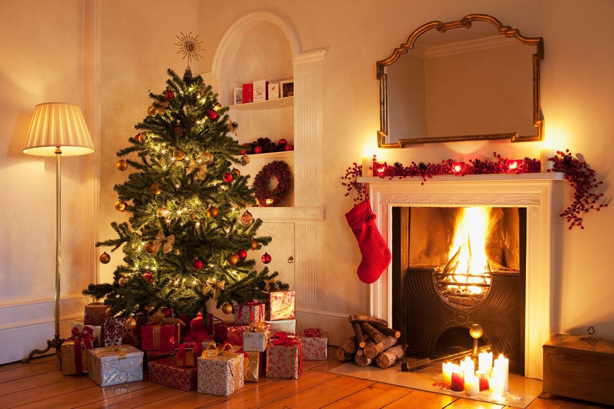 Christmas tree next to fireplace