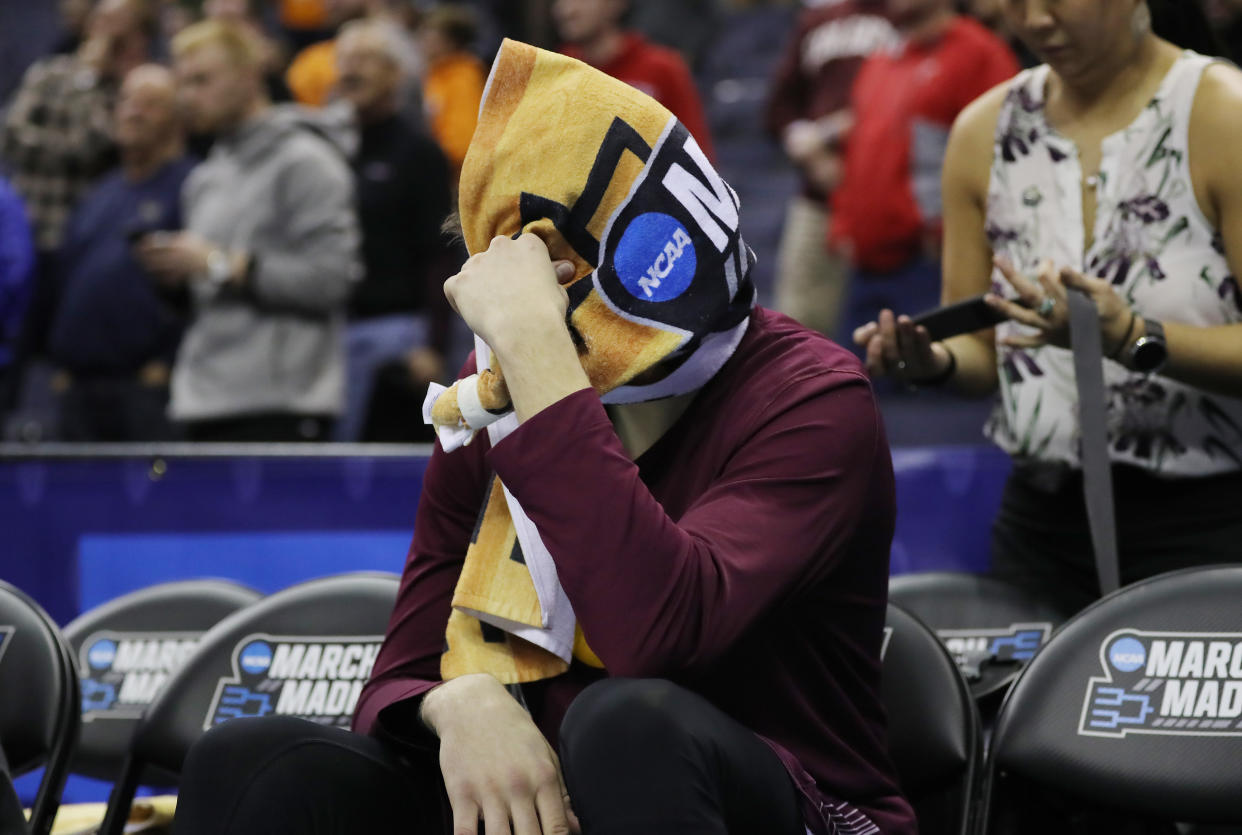Rapolas Ivanauskas spent part of Friday's game with a towel wrapped around his head on the bench. (Getty)