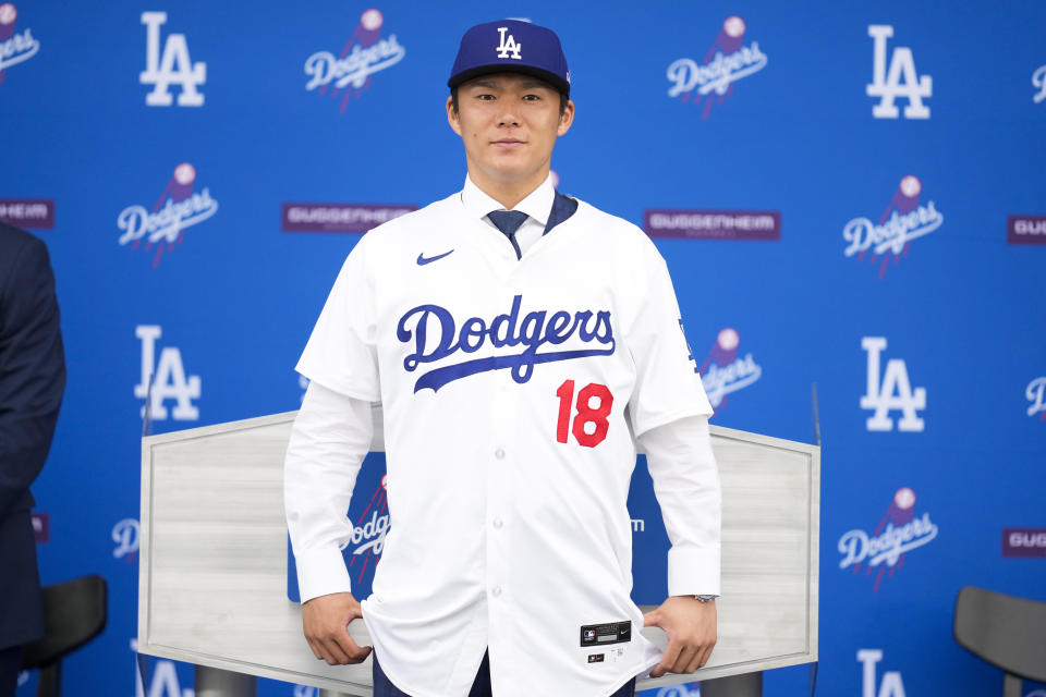 Yoshinobu Yamamoto wears his jersey during his introduction as a new member of the Los Angeles Dodgers baseball team Wednesday, Dec. 27, 2023, in Los Angeles. (AP Photo/Ashley Landis)