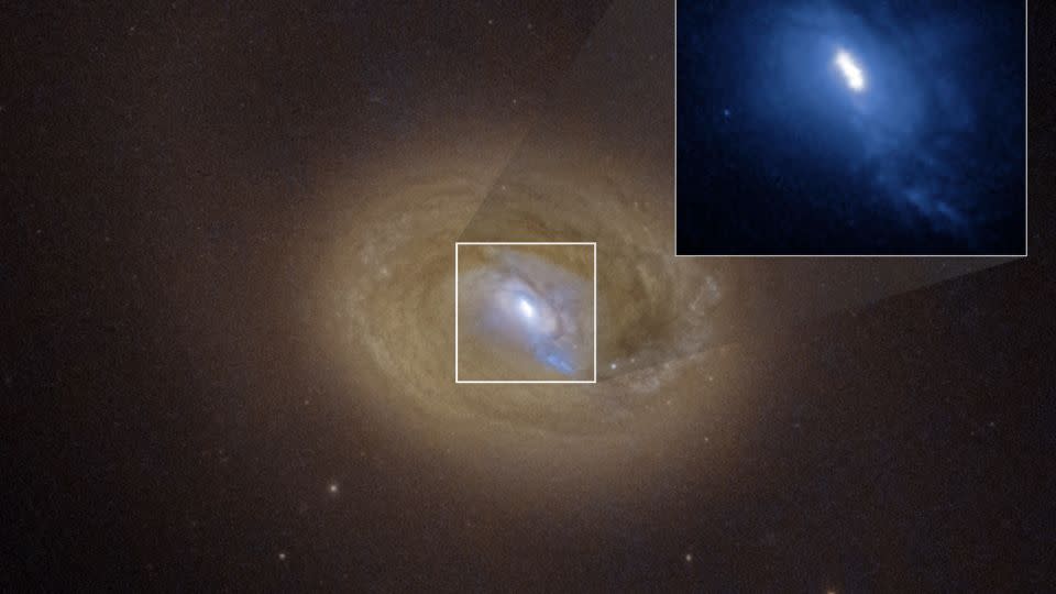 A Hubble Space Telescope image of the galaxy MCG-03-34-064 revealed three distinct bright spots embedded in a white ellipse at the galaxy's center (expanded in an inset image). - NASA/ESA/Anna Trindade Falcão (STScI)