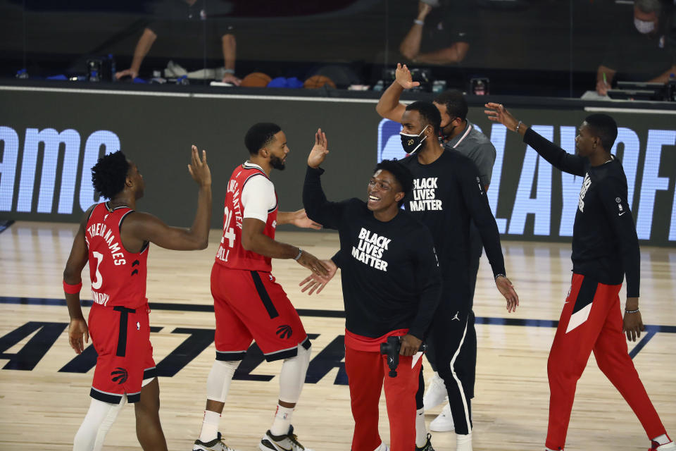 Toronto Raptors players high five after sweeping the Nets.