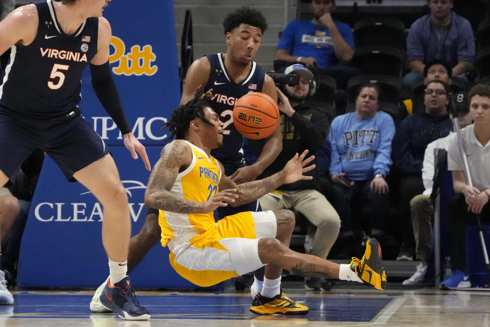 Pittsburgh guard Nike Sibande (22) loses control of the ball with Virginia guard Reece Beekman (2) defending during the first half of an NCAA college basketball game in Pittsburgh, Tuesday, Jan. 3, 2023. (AP Photo/Gene J. Puskar)