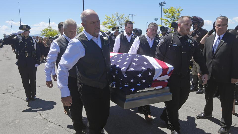 The casket of Santaquin Police Sgt. Bill Hooser is carried from Utah Valley University Monday, May 13, 2024, in Orem, Utah. Hooser was killed on May 5, 2024, while helping a Utah Highway Patrol trooper with a traffic stop when police say a man driving a semi-trailer intentionally hit Hooser. (AP Photo/Rick Bowmer)