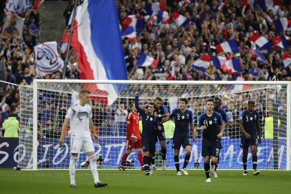 France's Antoine Griezmann, center, clenches his fist after scoring his second goal during their UEFA Nations League soccer match between France and Germany at Stade de France stadium in Saint Denis, north of Paris, Tuesday, Oct. 16, 2018. (AP Photo/Francois Mori)