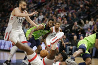 Toronto Raptors guard Kyle Lowry loses the ball as he falls while teammate Marc Gasol (33) and Minnesota Timberwolves forward Andrew Wiggins (22) look on in the second quarter of an NBA basketball game Saturday, Jan. 18, 2020, in Minneapolis. (AP Photo/Andy Clayton-King)