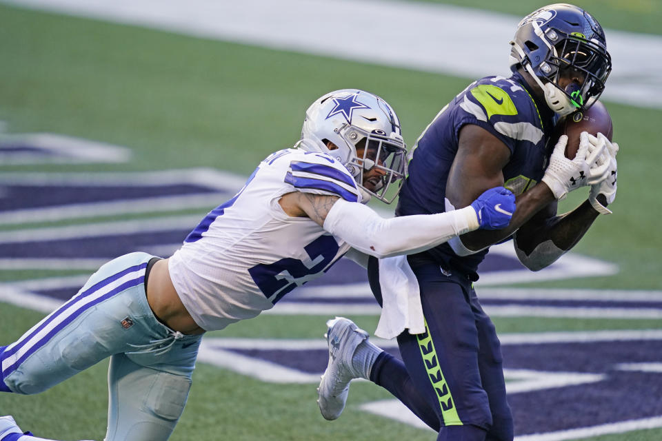 Seattle Seahawks wide receiver DK Metcalf, right, catches a pass for a touchdown ahead of Dallas Cowboys strong safety Darian Thompson, let, during the second half of an NFL football game, Sunday, Sept. 27, 2020, in Seattle. (AP Photo/Elaine Thompson)