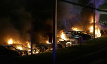 <p>Cars burn at a dealership Tuesday, Nov. 25, 2014, in Dellwood, Mo. A grand jury has decided not to indict Ferguson police officer Darren Wilson in the death of Michael Brown, the unarmed, black 18-year-old whose fatal shooting sparked sometimes violent protests. (AP Photo/Charlie Riedel) </p>