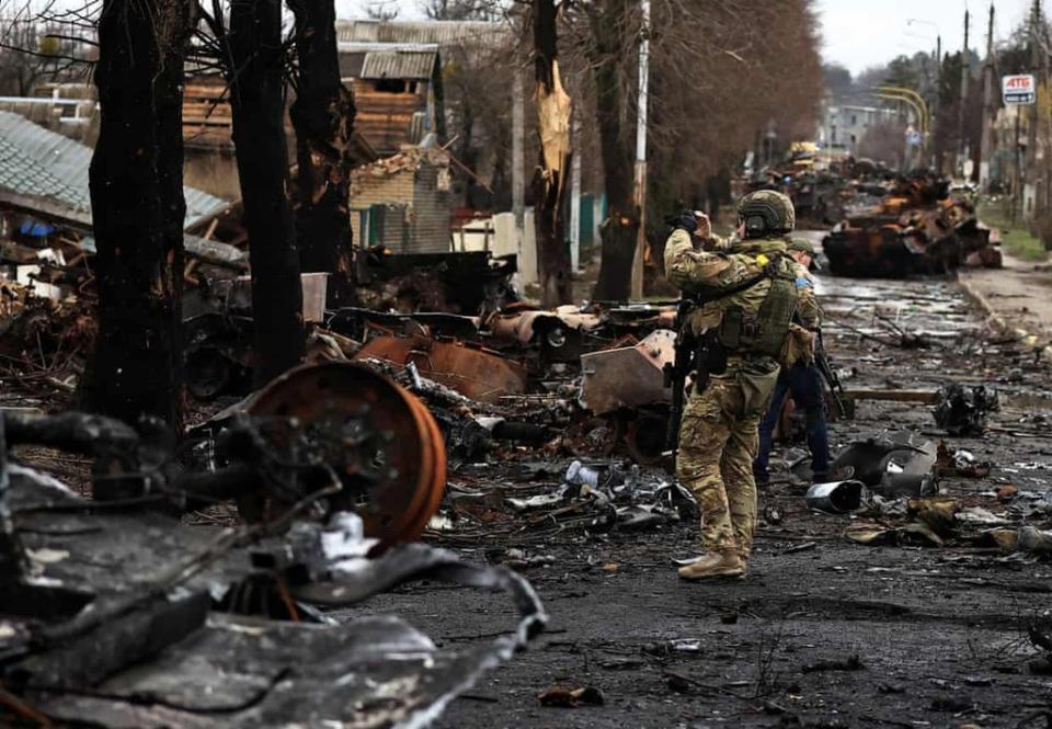 A soldier surveys the destruction left in Bucha (Reuters)