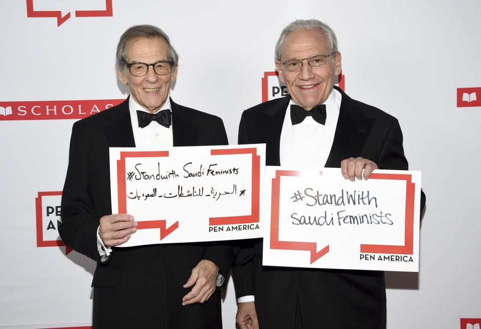 Author Robert Caro, left, and PEN literary service award recipient Bob Woodward pose together holding signs in support of jailed Saudi women's rights activists Nouf Abdulaziz, Loujain Al-Hathloul and Eman Al-Nafjan at the 2019 PEN America Literary Gala at the American Museum of Natural History on Tuesday, May 21, 2019, in New York. (Photo by Evan Agostini/Invision/AP)