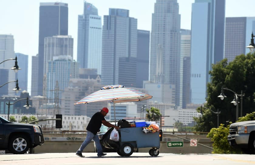 -ME- June 14, 2021: A vendor walks in East L.A. during a heat wave in Southern California Monday. (Wally Skalij / Los Angeles Times)