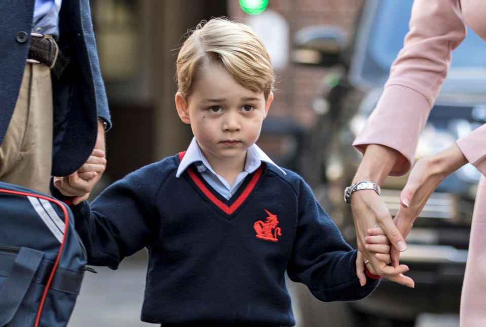 Helen Haslem, head of the lower school and Britain's Prince William hold Prince George's hands as he arrives for his first day of school at Thomas's school in Battersea, London, September 7, 2017. REUTERS/Richard Pohle/Pool