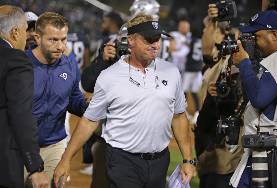 Oakland Raiders head coach Jon Gruden walks off the field after shaking hands with Los Angeles Rams head coach Sean McVay, left, at the end of an NFL football game in Oakland, Calif., Monday, Sept. 10, 2018. Los Angeles won the game 33-13. (AP Photo/John Hefti)