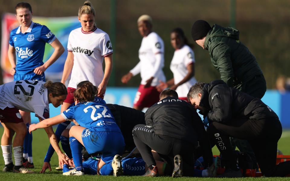 Everton's Karoline Olesen receives medical treatment /Women's Super League reality check after just 997 fans turn up for Everton v West Ham