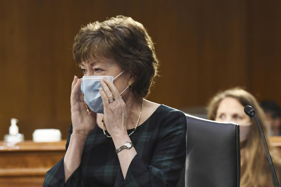 Sen. Susan Collins, R-Maine, adjusts her mask before a Senate Committee for Health, Education, Labor, and Pensions hearing, Tuesday, May 12, 2020 on Capitol Hill in Washington. Dr. Anthony Fauci, director of the National Institute of Allergy and Infectious Diseases, is to testify before the committee. (Toni L. Sandys/The Washington Post via AP, Pool)