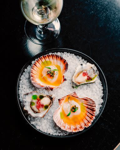 <p>Courtesy of Corella</p> Corella’s oysters with finger lime and scallops with lemon myrtle ponzu and pickled chile